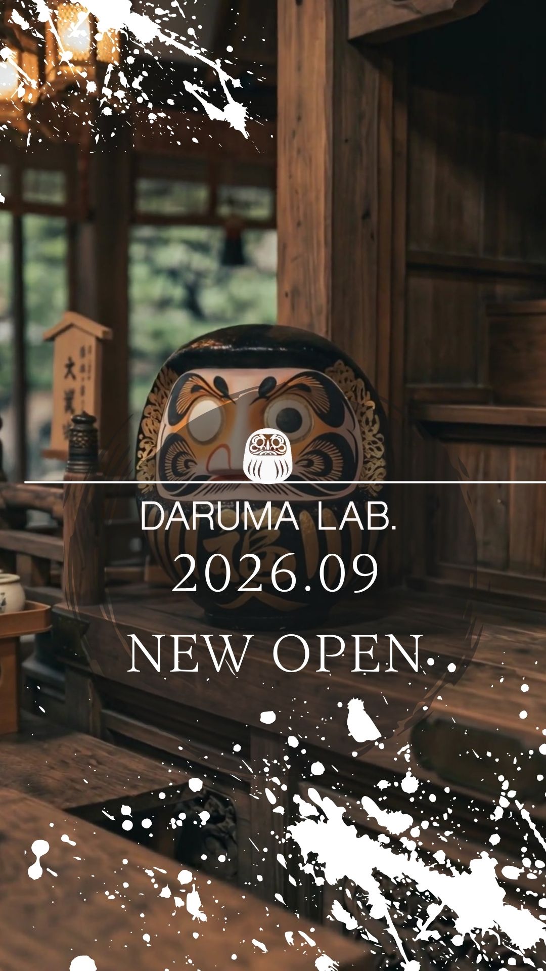 DARUMA LAB. opening September 2026 — a gold and black Daruma doll in a traditional wooden studio