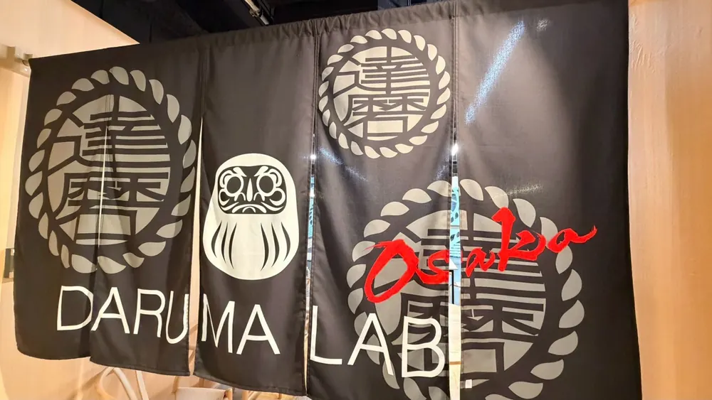 The DARUMA LAB. Osaka noren curtain hanging at the entrance of the Shinsaibashi studio